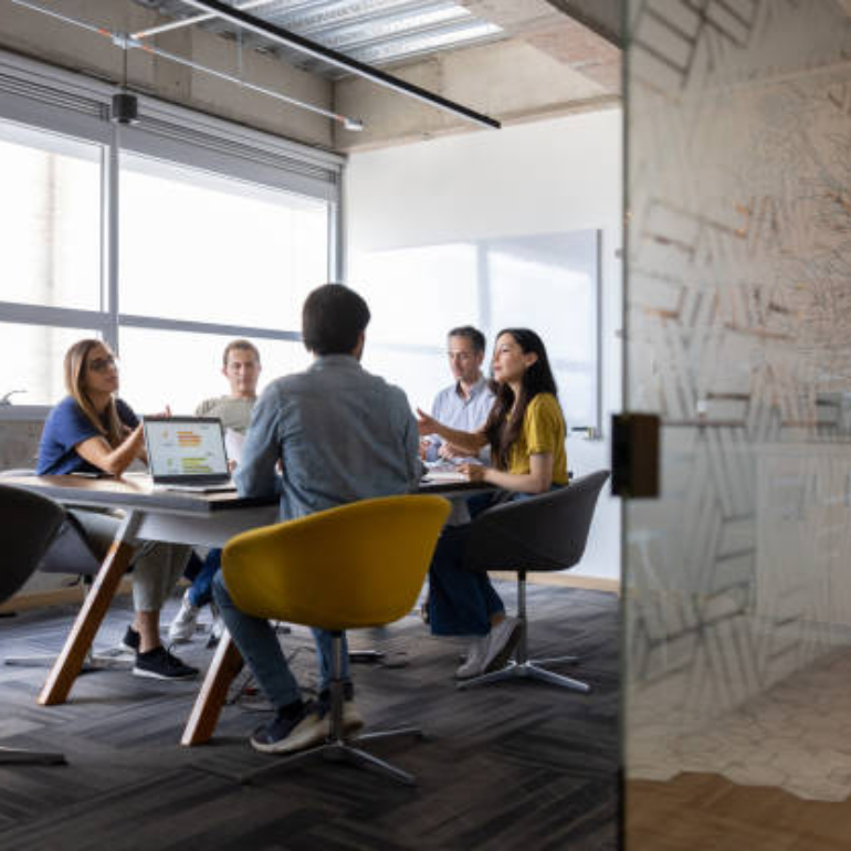 Group of Latin American business people talking in a meeting at the office