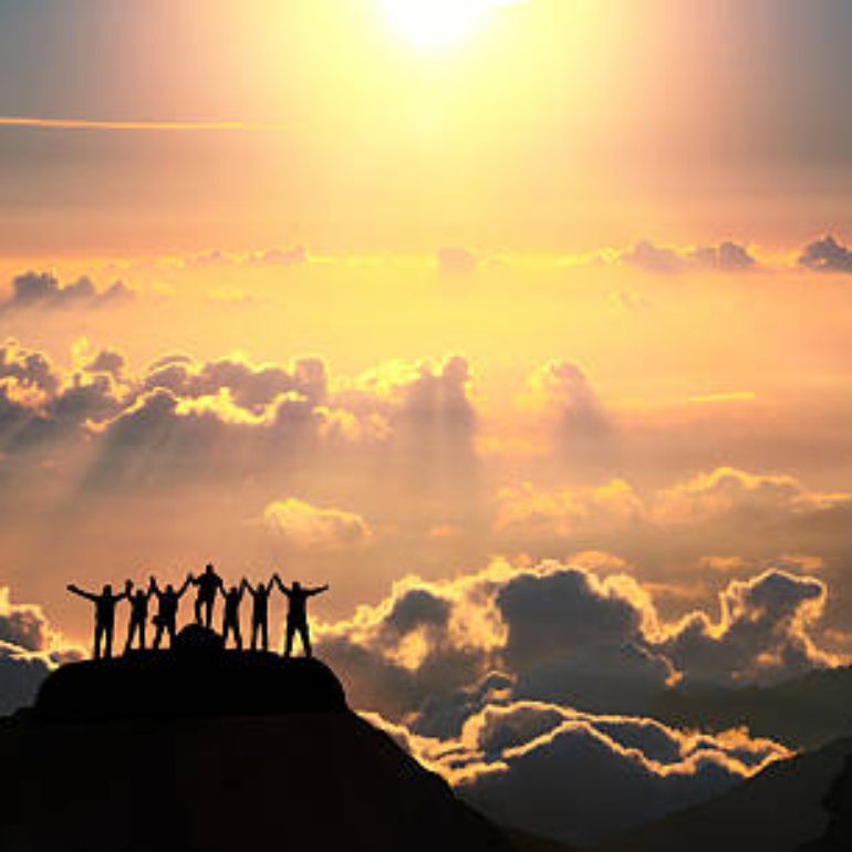 A group of people standing on a hill over the beautiful cloudscape.
